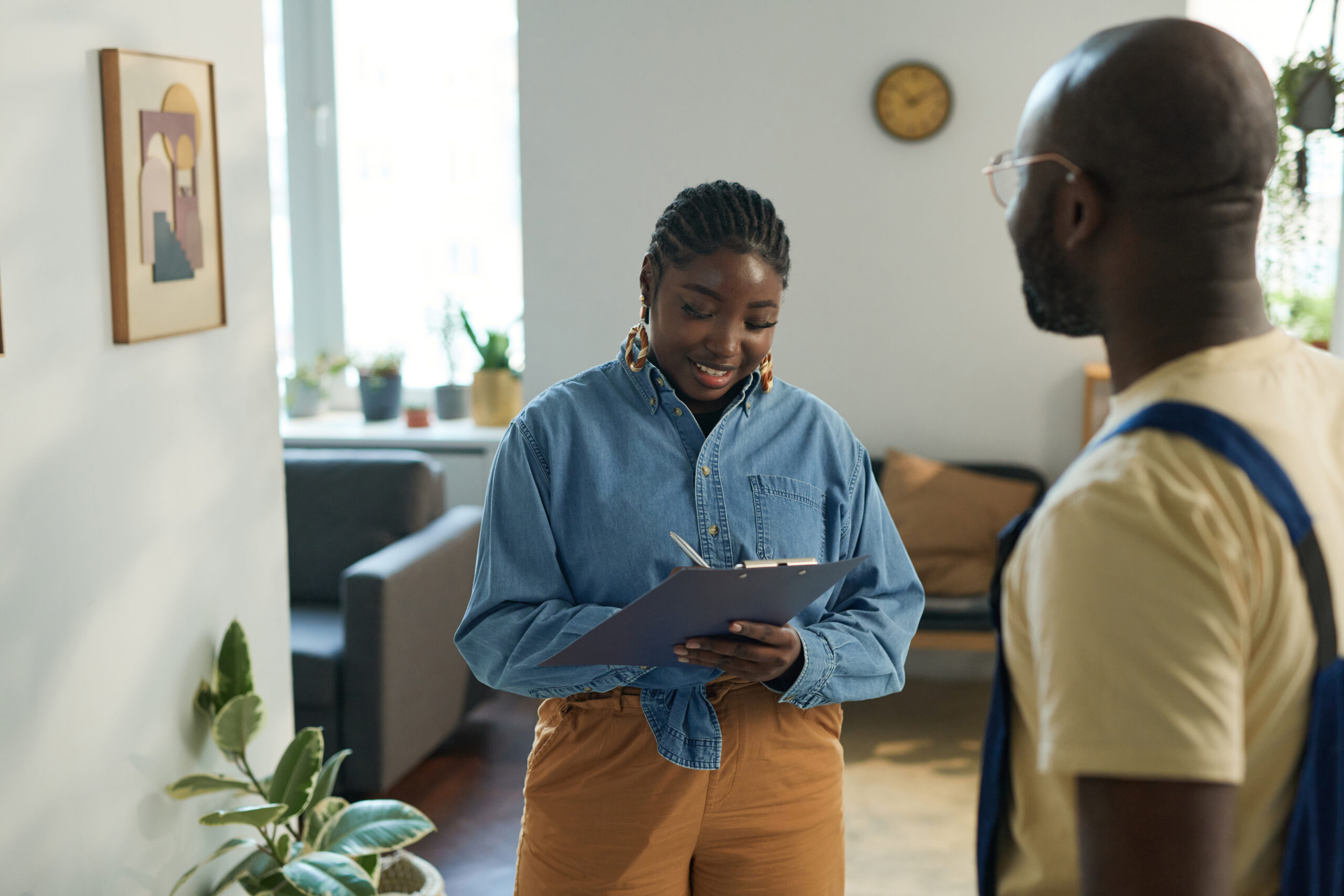African American woman signing energy efficiency contract 
